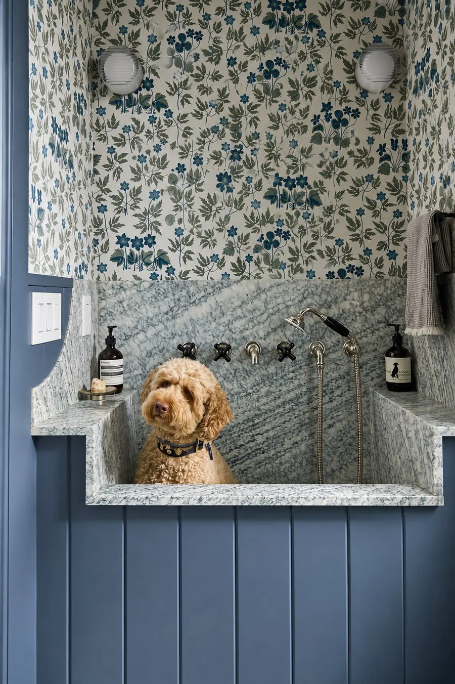 Marble dog-wash station with blue panelling and floral wallpaper